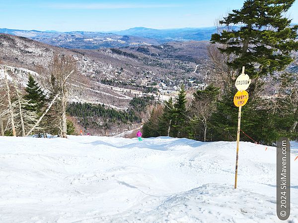 Top of a mogul run with sign that says experts only