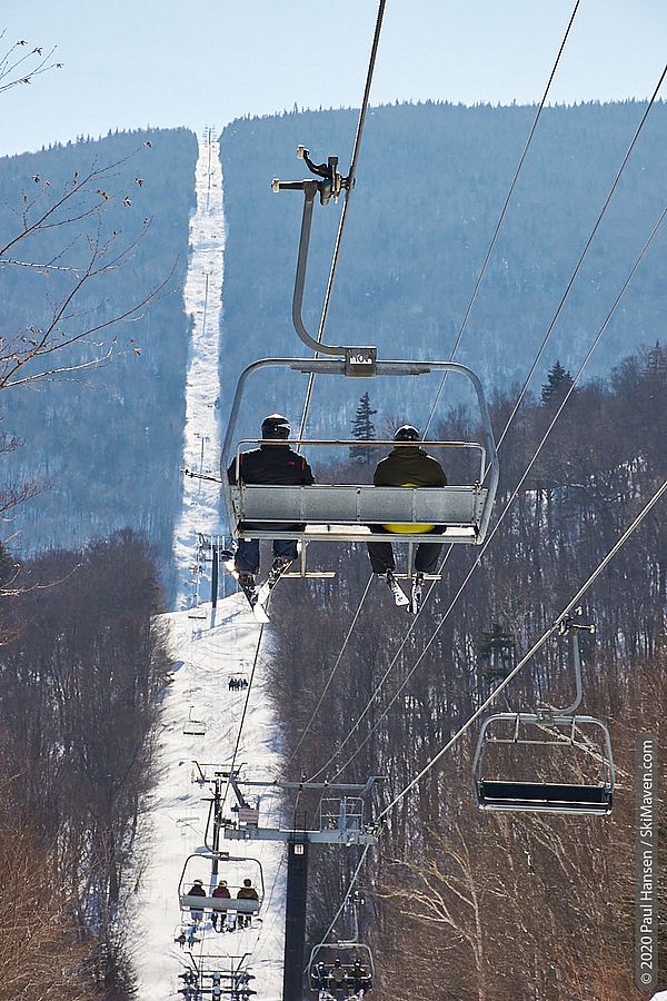 Photo of people riding on the 2-mile-long Slide Brook Express chairlift