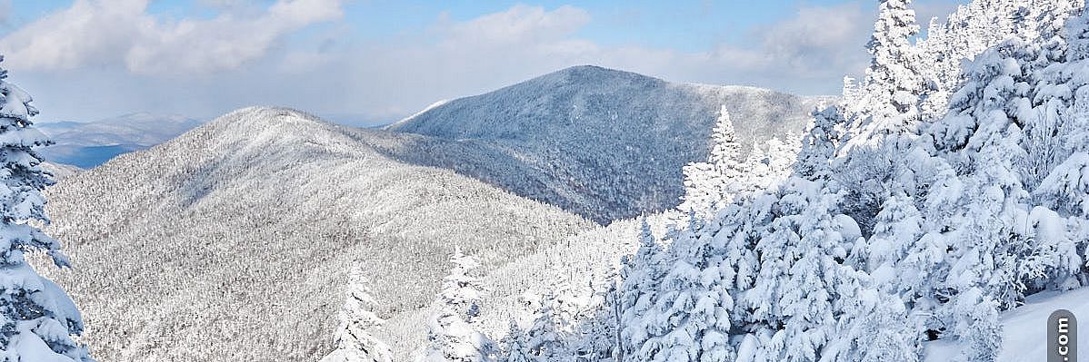 Photo of snowy ski slope with mountain views