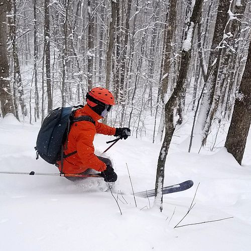 Telemark skier charges through some powder