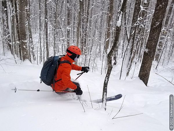 Telemark skier charges through some powder