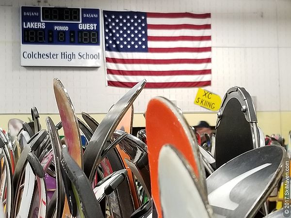 Skis stand on a rack in a school gym