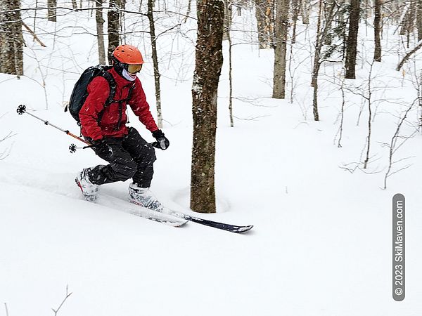 Telemark skier makes a tele turn in some fresh snow