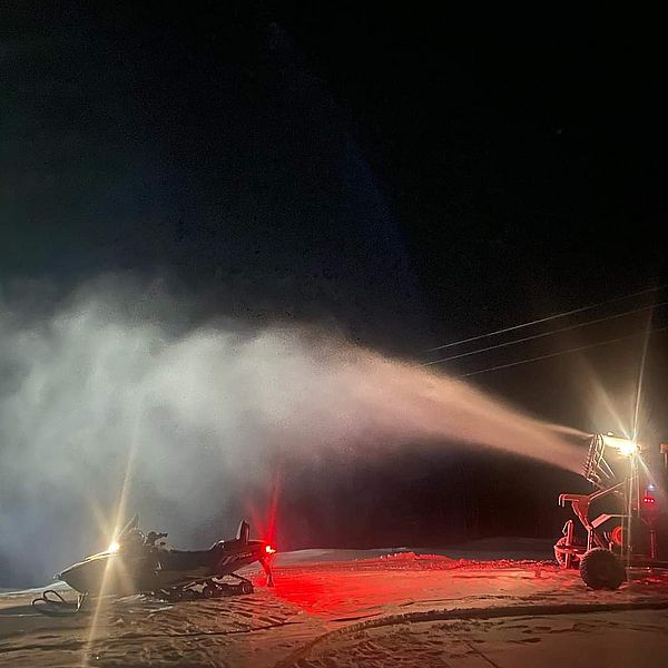 Snowmaking on a ski slope at night