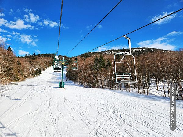 Springy snow and blue sky seen from chairlift