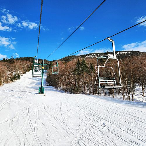 Springy snow and blue sky seen from chairlift