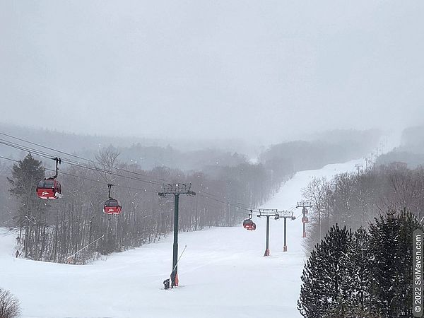 Photo of the red Stowe gondola cars ascending the mountain