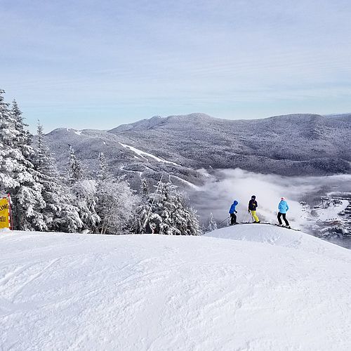 Photo of skiers on snowmaking whales on the Upper Hayride expert run