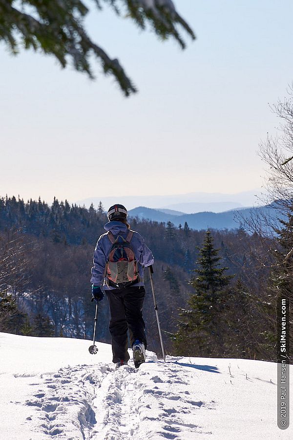 Photo of skier and her tracks through the snow