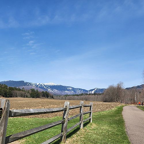 Photo of a rather snowy Mt. Mansfield as seen from the dry Stowe Recreation Path