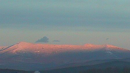 Snowy Mt. Mansfield in the glow of the setting sun.