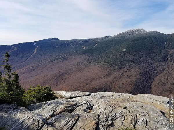 Photo of rocky cliff with a mountain view