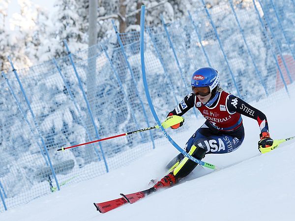 Mikaela Shiffrin ski racing and knocking a slalom gate out of the way
