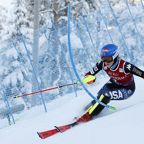 Mikaela Shiffrin ski racing and knocking a slalom gate out of the way