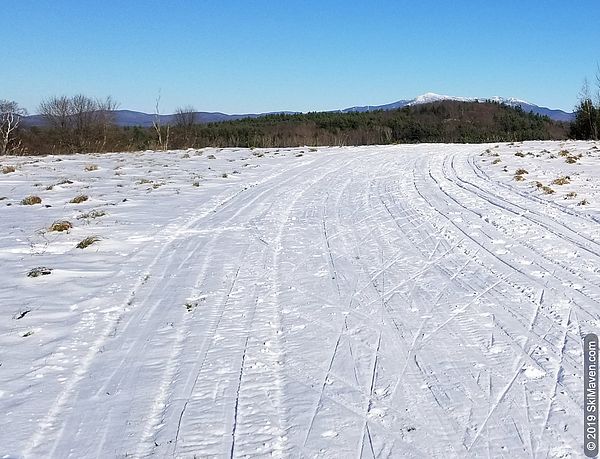 Photo of cross-country ski trail and Mt. Mansfield in distance