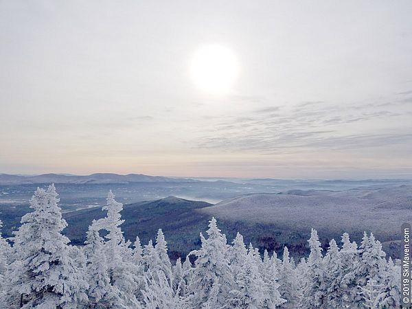 Photo of a hazy sun and mountain view from the top of the quad