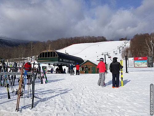 Photo of people in snowy base area in Stowe, Vermont