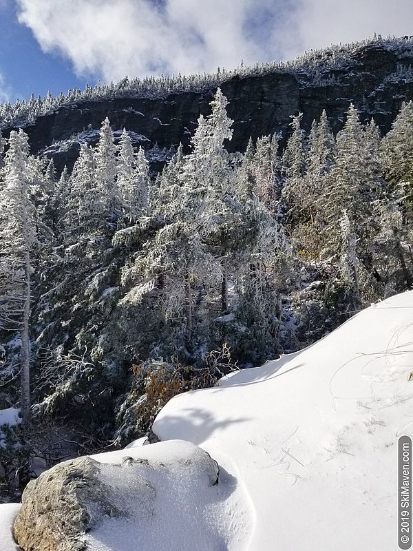 Snowy rocks, trees and cliff at the top of the gondola on Mt. Mansfield