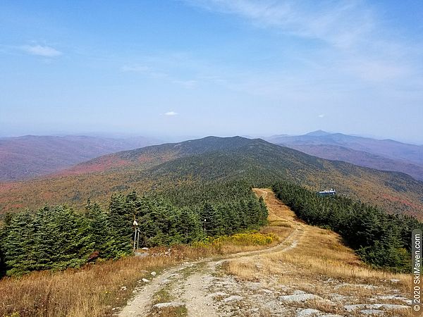 Photo of grassy mountain top with mountain views