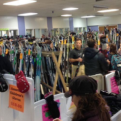 Photo of a Vermont ski swap with lots of skis, gear and people