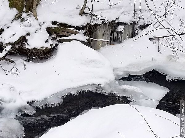 Icicles in a partly frozen stream