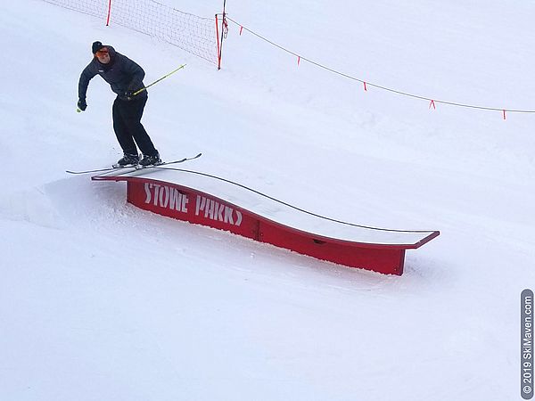 Photo of a skier doing a trick on a park feature