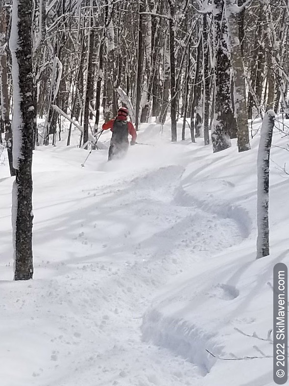 Skier makes S turns in the powdery snow