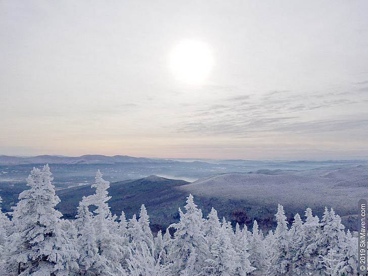 Photo of a hazy sun and mountain view from the top of the quad